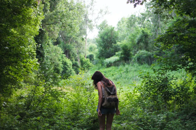 Eine Frau, die als Plastikreporter mitmacht, sucht nach Müll im Wald